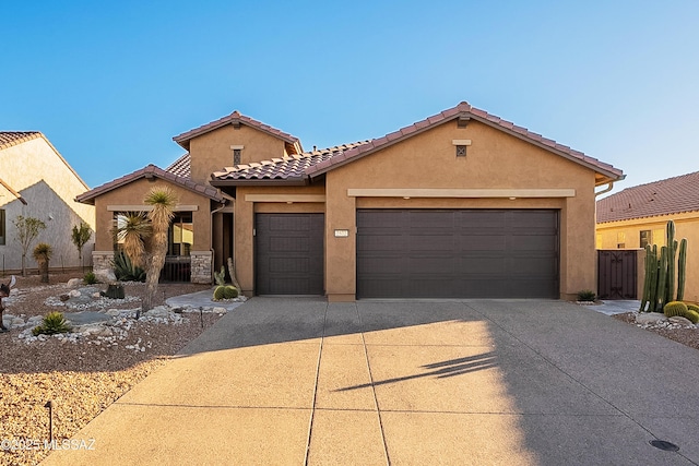 mediterranean / spanish-style home with a garage