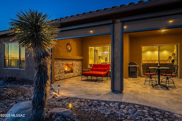 view of patio / terrace featuring an outdoor stone fireplace