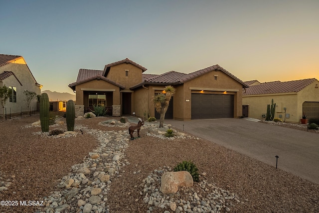 mediterranean / spanish home featuring a garage