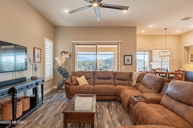 living room featuring plenty of natural light, dark hardwood / wood-style floors, and ceiling fan