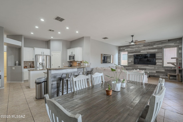 tiled dining area with ceiling fan