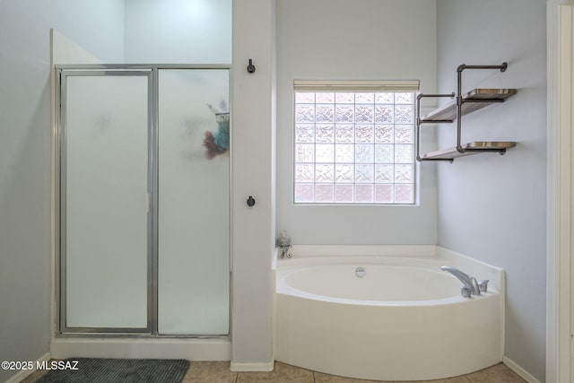 bathroom featuring tile patterned flooring and independent shower and bath