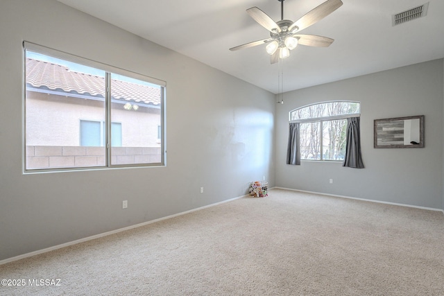 empty room featuring ceiling fan and carpet floors