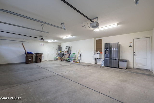 garage featuring a garage door opener, stainless steel refrigerator with ice dispenser, and gas water heater