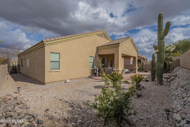 rear view of property featuring a patio