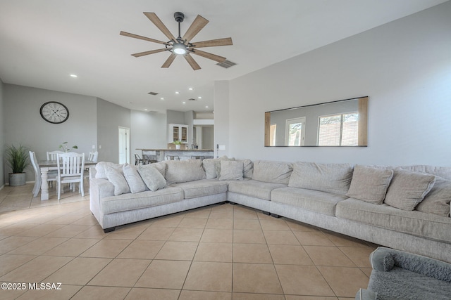 tiled living room with ceiling fan