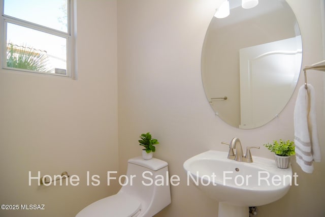 bathroom featuring sink and toilet