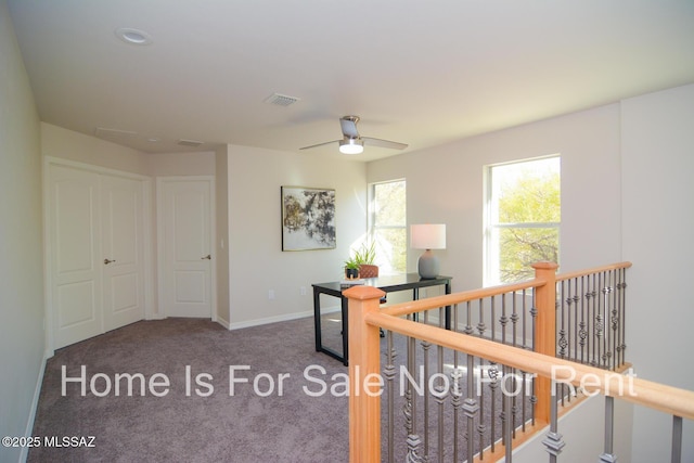 office space with ceiling fan and carpet