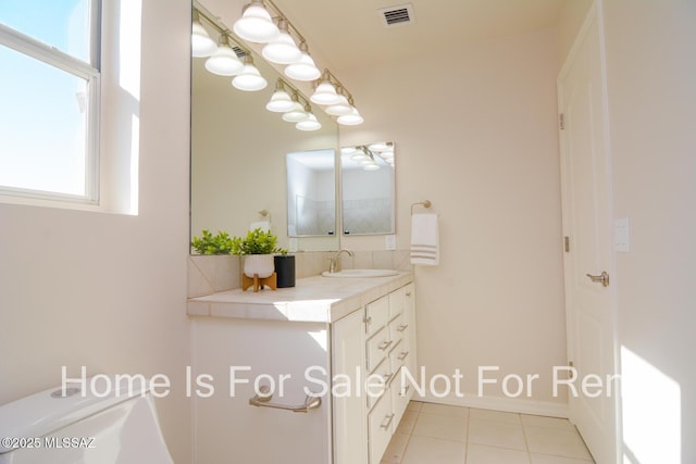 bathroom featuring vanity, tile patterned floors, and toilet