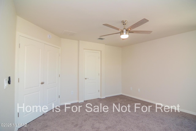 unfurnished bedroom with a closet, ceiling fan, and carpet flooring