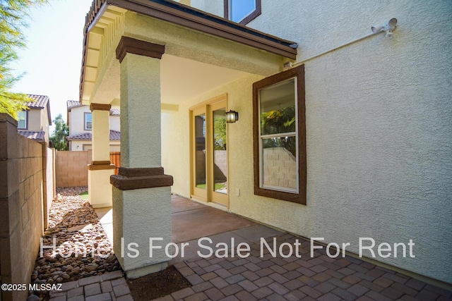 entrance to property featuring a patio area