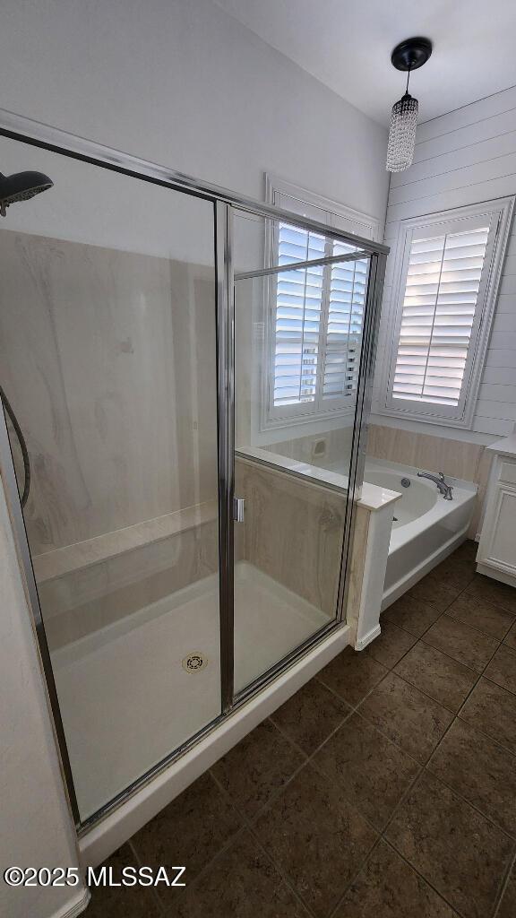 bathroom featuring plus walk in shower and tile patterned floors