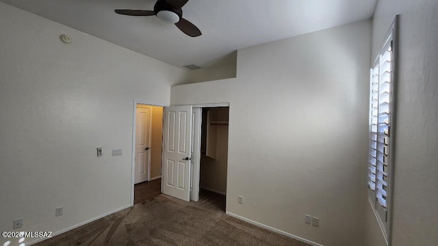 unfurnished bedroom featuring ceiling fan, dark carpet, and a closet