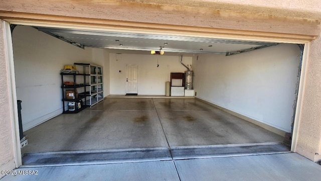 garage with a garage door opener and gas water heater