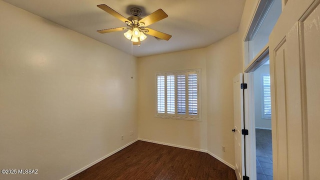 spare room with ceiling fan and dark hardwood / wood-style floors