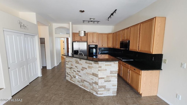 kitchen featuring pendant lighting, a center island with sink, tile patterned floors, and appliances with stainless steel finishes