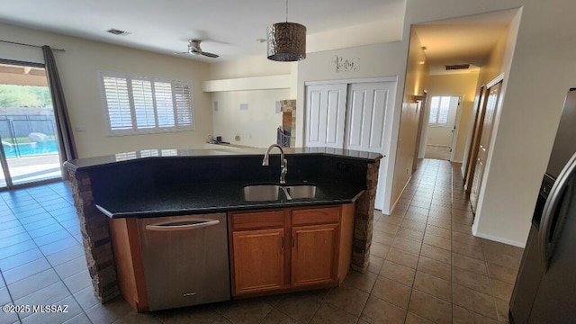 kitchen featuring dark tile patterned floors, a wealth of natural light, sink, and pendant lighting