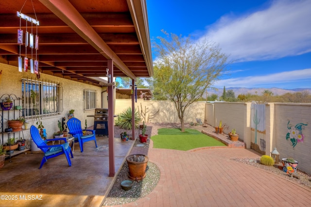 view of patio / terrace featuring a mountain view and a grill