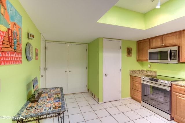 kitchen featuring stainless steel appliances and light tile patterned floors