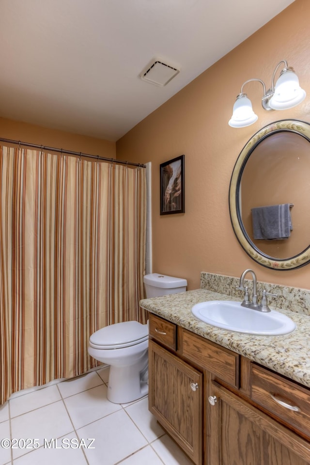 bathroom featuring vanity, toilet, and tile patterned flooring