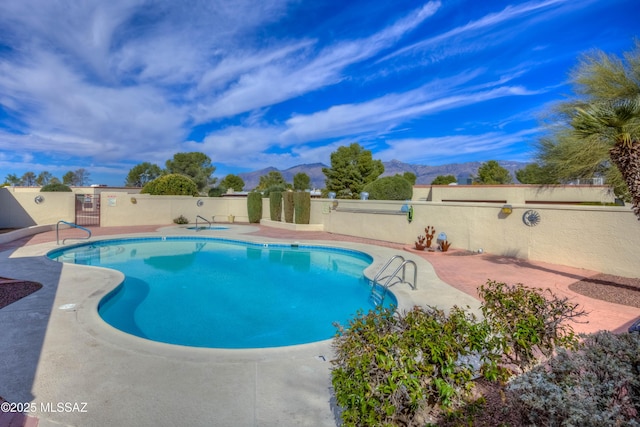 view of pool with a mountain view and a patio area