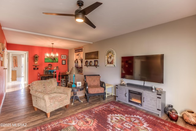 living room featuring hardwood / wood-style floors and ceiling fan with notable chandelier