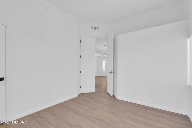 spare room featuring light wood-type flooring