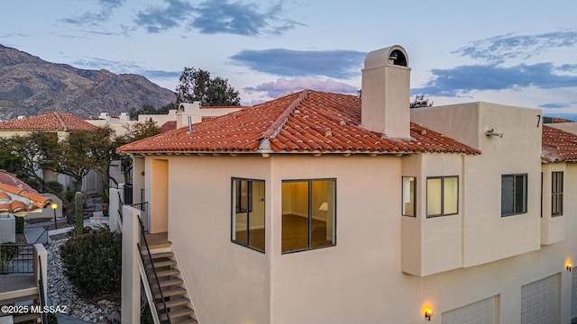 view of side of property with a mountain view and a garage