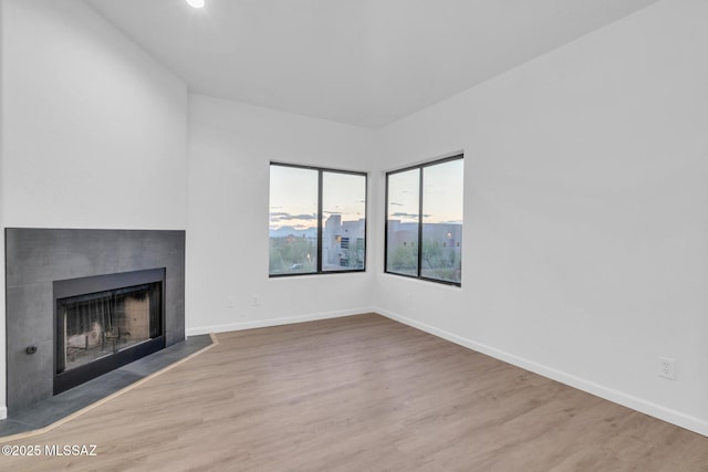 unfurnished living room featuring wood-type flooring