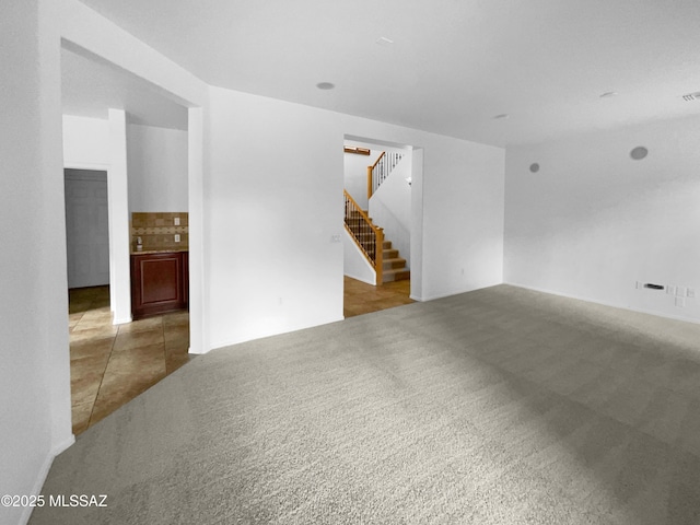 unfurnished room featuring light colored carpet