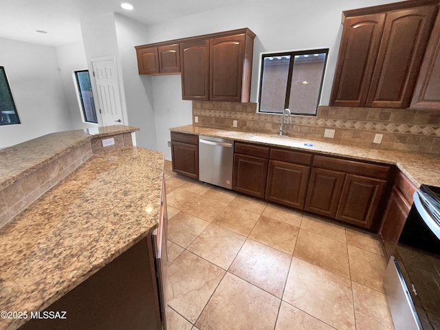 kitchen featuring sink, decorative backsplash, stainless steel dishwasher, electric range, and light stone counters