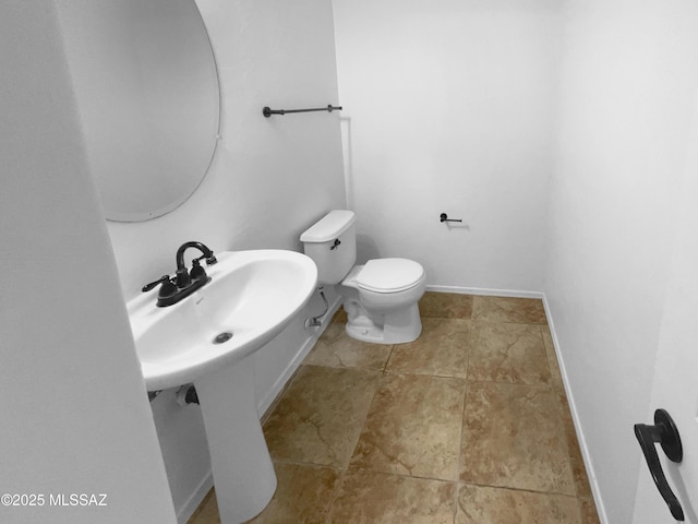 bathroom with tile patterned flooring and toilet