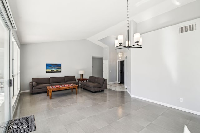 living room featuring a notable chandelier and high vaulted ceiling