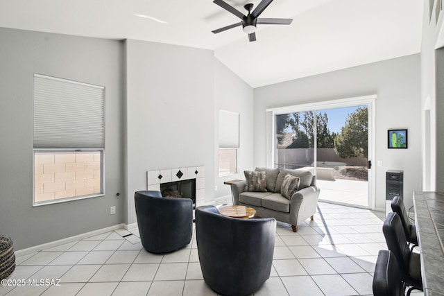 living room featuring light tile patterned flooring, ceiling fan, lofted ceiling, and a fireplace