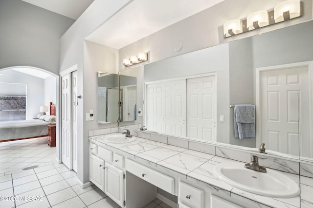 bathroom with tile patterned flooring and vanity