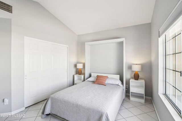 tiled bedroom with lofted ceiling