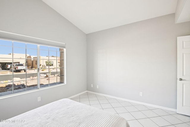 bedroom featuring vaulted ceiling and light tile patterned floors