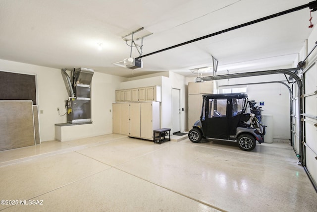 garage with a garage door opener and heating unit