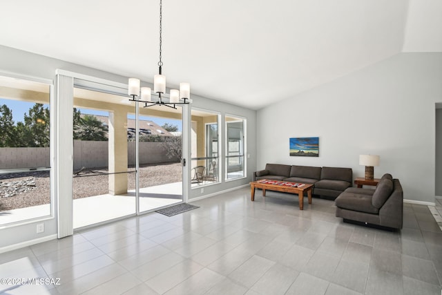 living room with vaulted ceiling and a chandelier