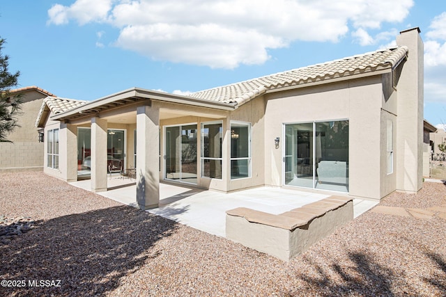 back of house with a patio