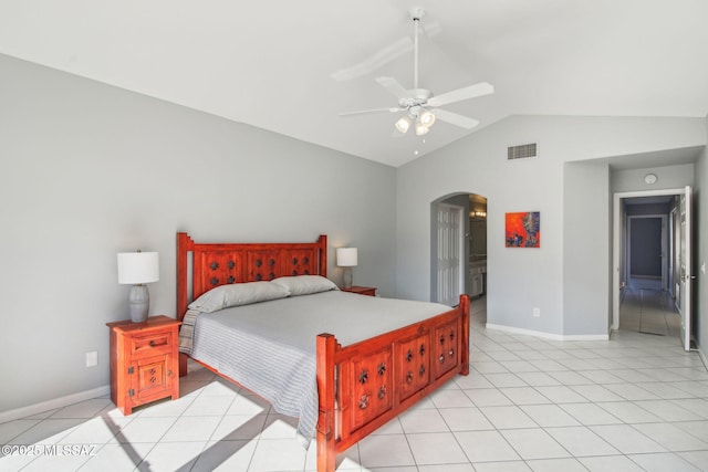 tiled bedroom featuring vaulted ceiling, ensuite bathroom, and ceiling fan