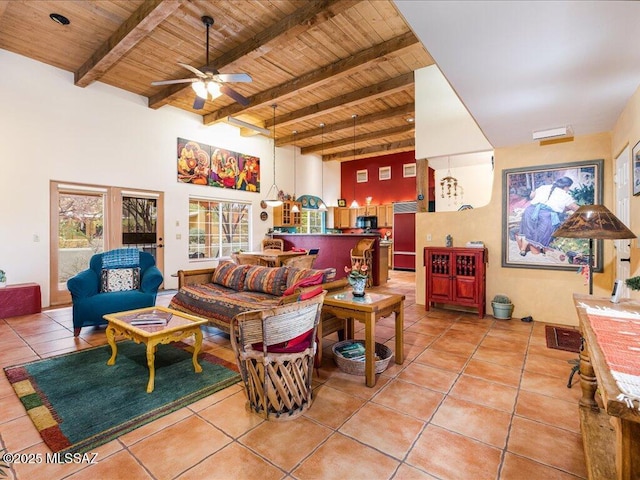 living room with beamed ceiling, a high ceiling, light tile patterned floors, and wooden ceiling