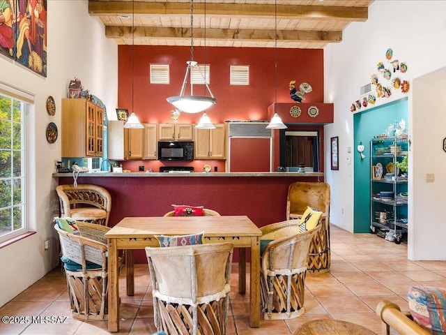 tiled dining area featuring wooden ceiling, beamed ceiling, and a high ceiling