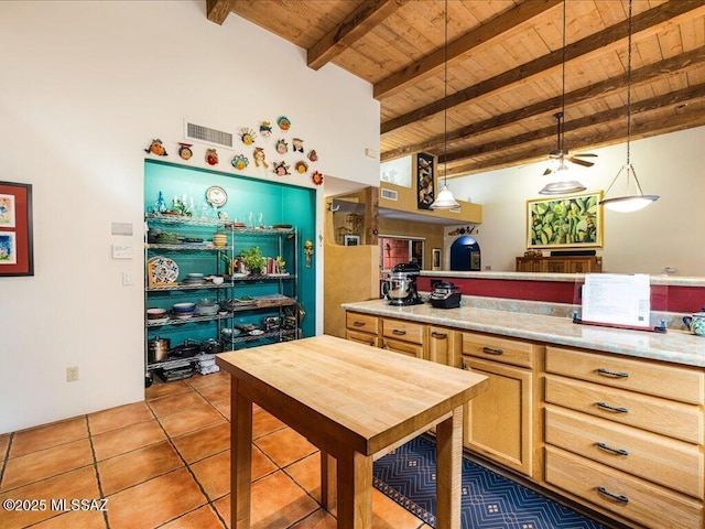 kitchen with vaulted ceiling with beams, pendant lighting, tile patterned floors, and wood ceiling