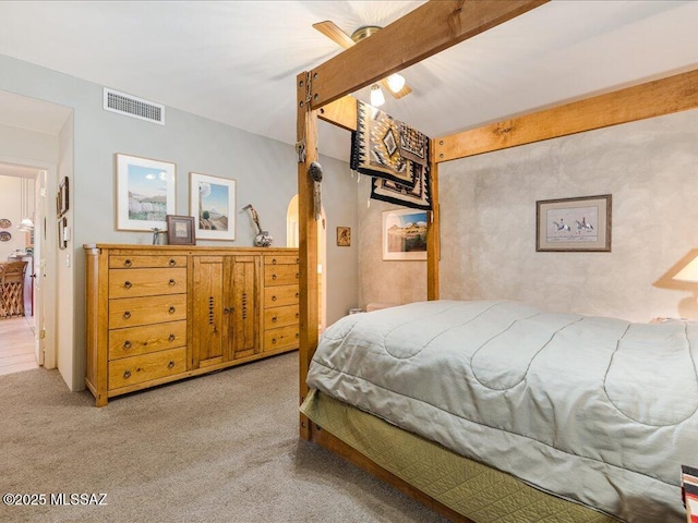 carpeted bedroom featuring beam ceiling