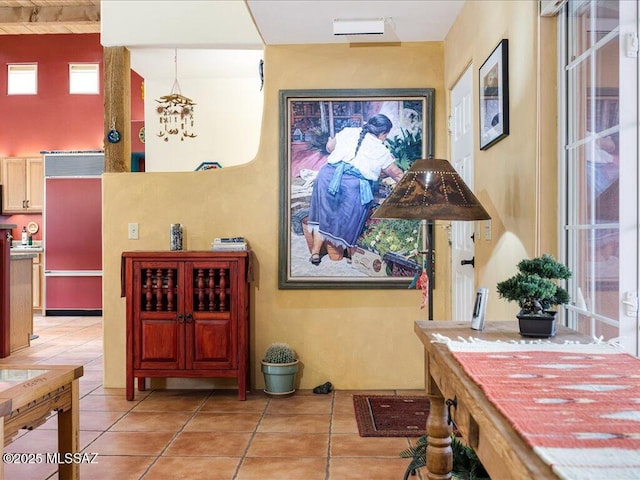 interior space featuring a high ceiling and light tile patterned floors