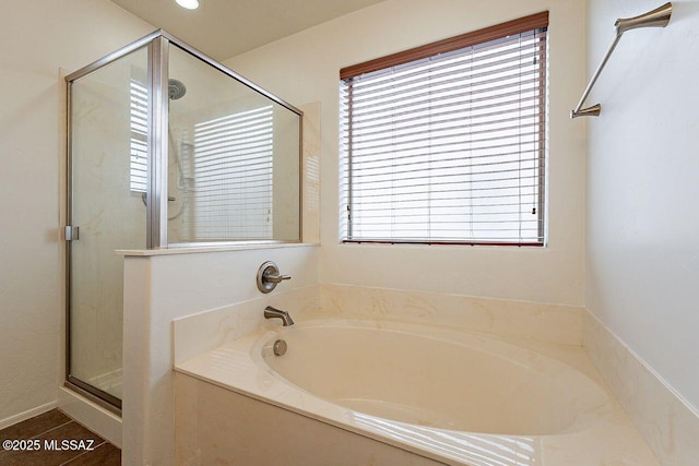 bathroom featuring tile patterned flooring, shower with separate bathtub, and plenty of natural light