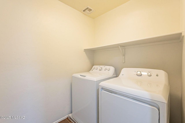 clothes washing area featuring washing machine and dryer