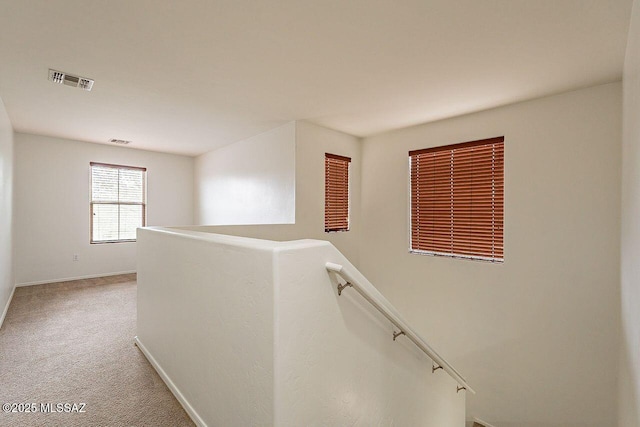 hallway with carpet floors