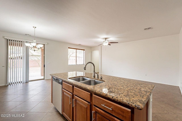 kitchen with hanging light fixtures, dishwasher, an island with sink, ceiling fan with notable chandelier, and sink